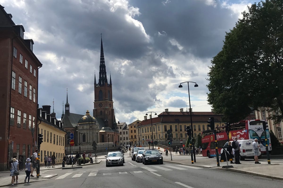 “Historic tower along a scenic Stockholm street — cobblestone roads, classic architecture, and luxury Swedish city charm, TripsWithSam Sweden itinerary.”