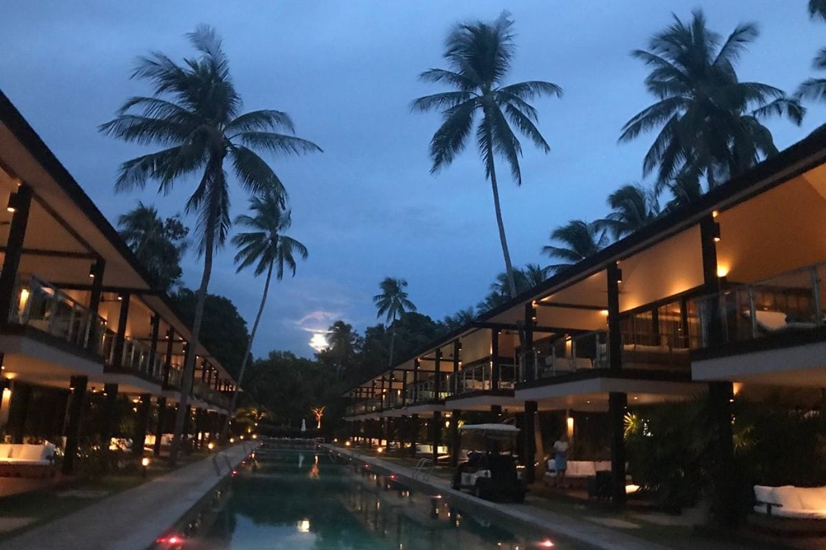 Oceanfront pool and cabanas at Nikki Beach Resort Koh Samui with sunset view