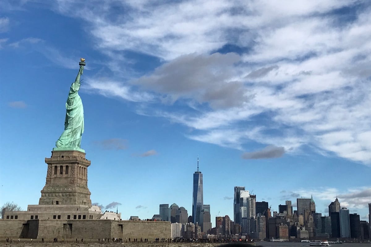 “Statue of Liberty with Manhattan skyline backdrop — symbol of freedom, iconic architecture, and curated luxury New York experiences, TripsWithSam USA itinerary.”