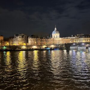 The Pont Alexandre III bridge at twilight, overlooking the Seine with the Eiffel Tower beyond — a portrait of Parisian grandeur.