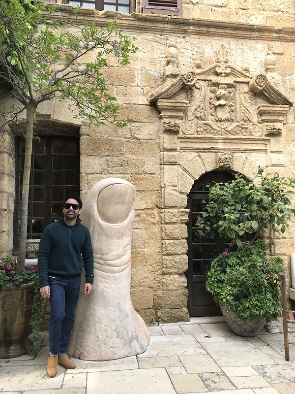 Sam Bhandari beside a giant thumb sculpture in Saint-Paul-de-Vence, Provence, France